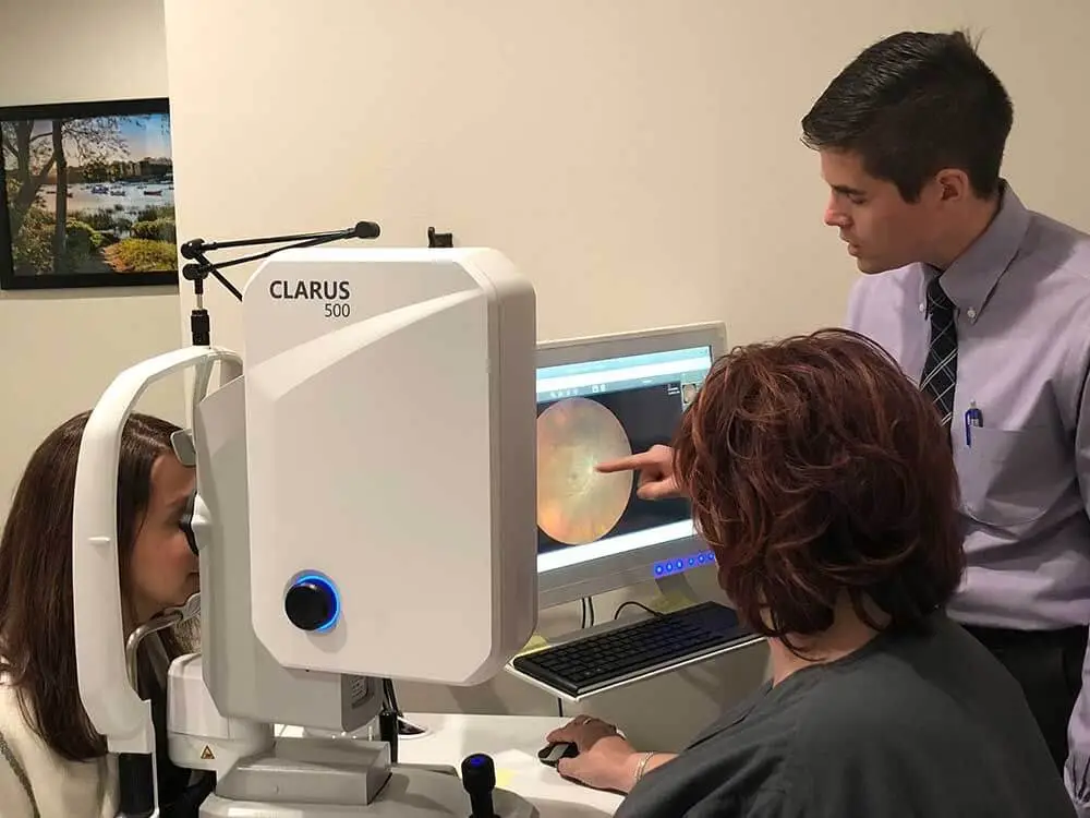 Dr. Barton reviewing an image of a patient's eye during her eye exam