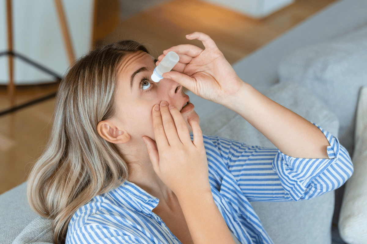 a woman putting in eye drops for dry eye