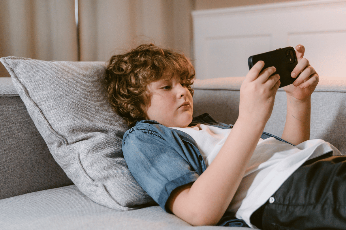 a kid looking at a phone at home
